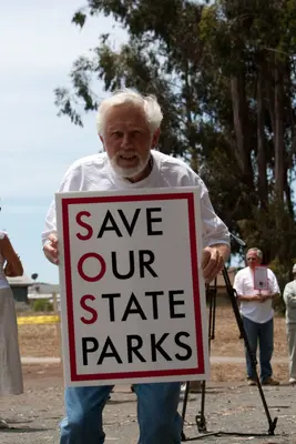 Chuck Mills holds SOSP sign. SOSP Save our State Parks Public Rally at the Pismo Butterfly Grove, Pismo, CA, 06 June 2009, to protest the proposed closure of most of the CA State Parks (3602122939)