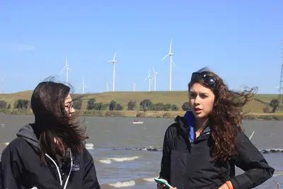 Student presentations on Sherman Island, overlooking Shiloh Wind Power Plant.
