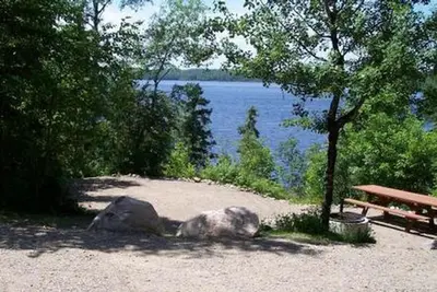 Picture of campsite and lake in the background.