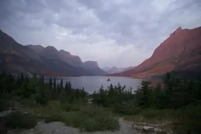A scenic view of a lake surrounded by rocky peaks
