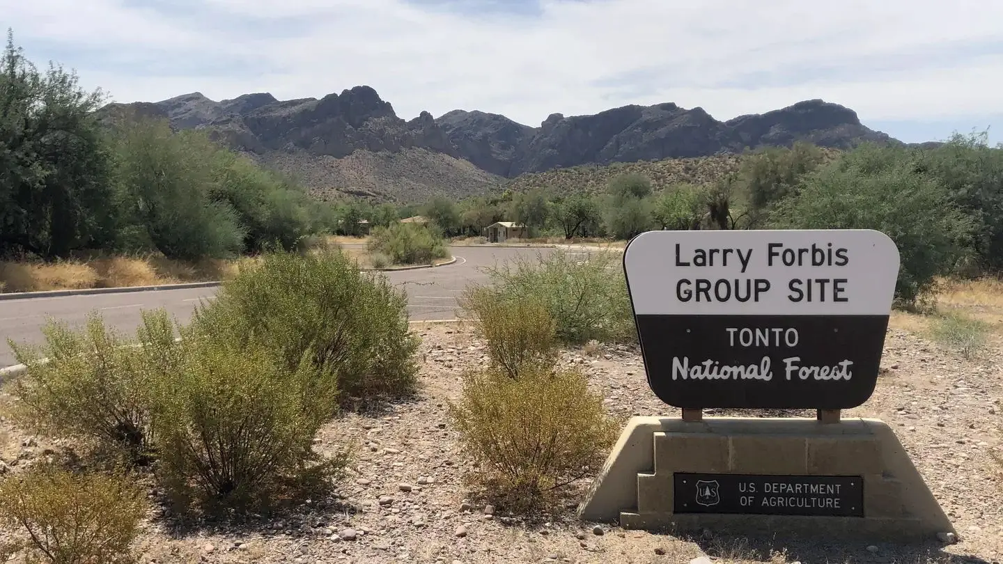 Larry Forbis Group Site sign with desert background