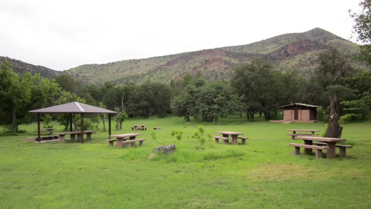Grassy picnic area with bathroom and small ramada