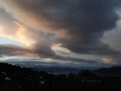 Dramatic clouds and distant snow-capped mountains