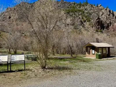 A view of East Portal Campground with wayside signs and restrooms