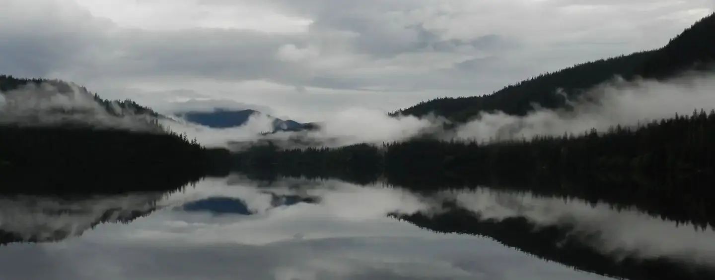 View of lake and mountains from Virginia Lake Cabin with misty clouds over lake