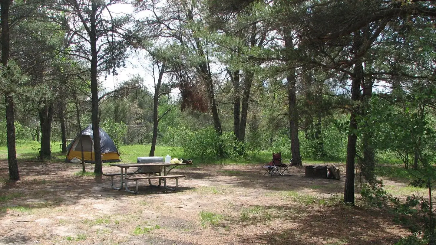 A campsite with a tent set up on it in the Meadows ORV Campground.