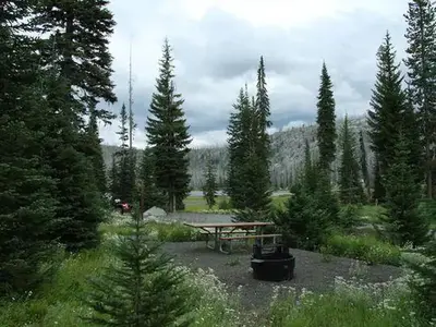 Forested campsite with Hazard Lake in the distance.