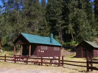 Deer Park Cabin, with water pump house in background.
