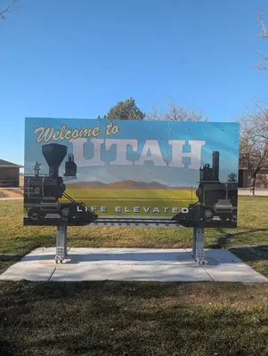 A welcome sign Idaho Utah border