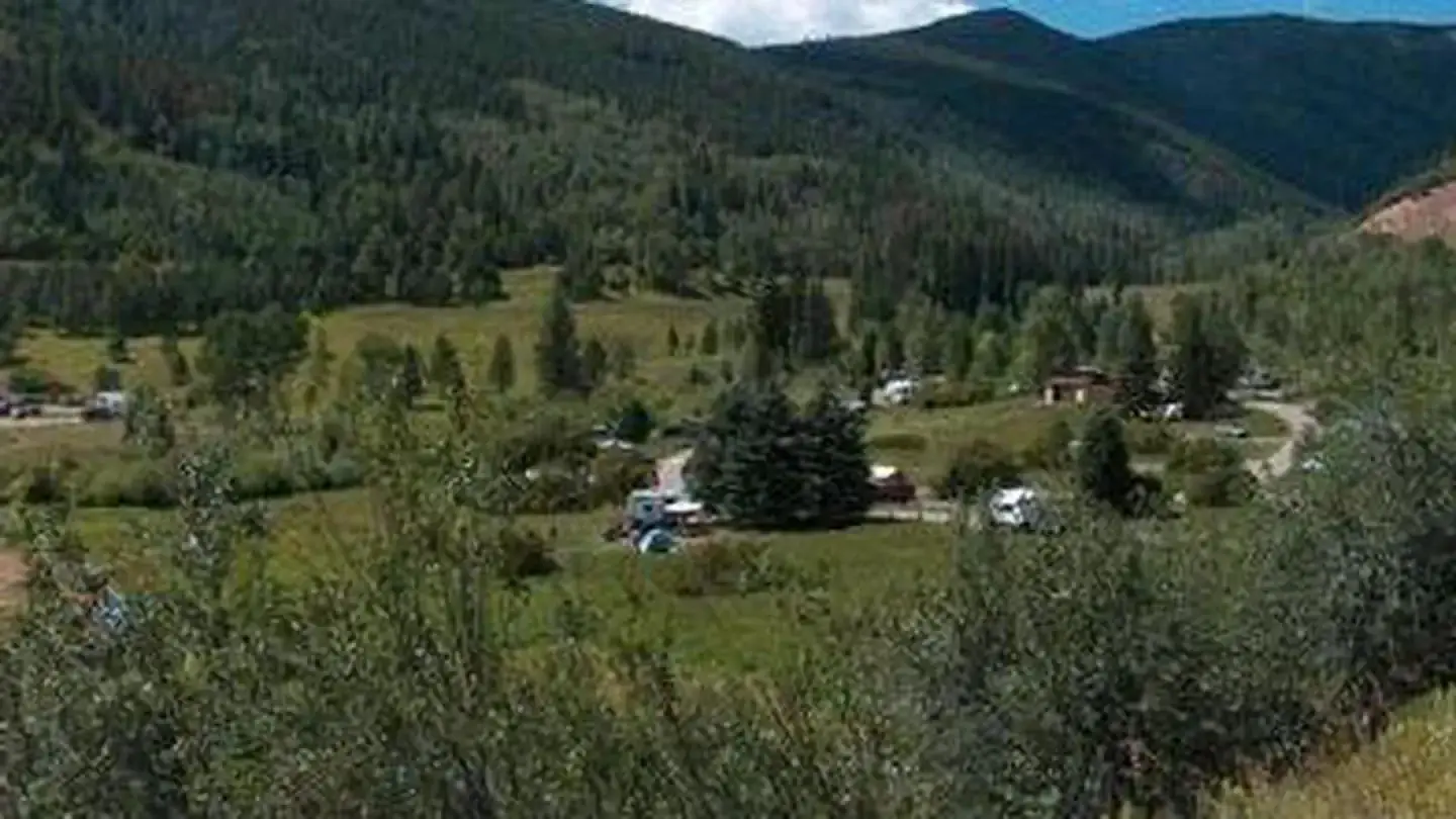 Campground situated in a lush mountain valley.