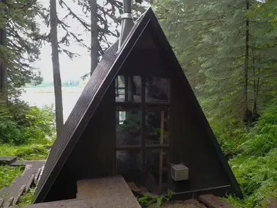 Mount Flemer Cabin exterior from behind showing water and trees in front