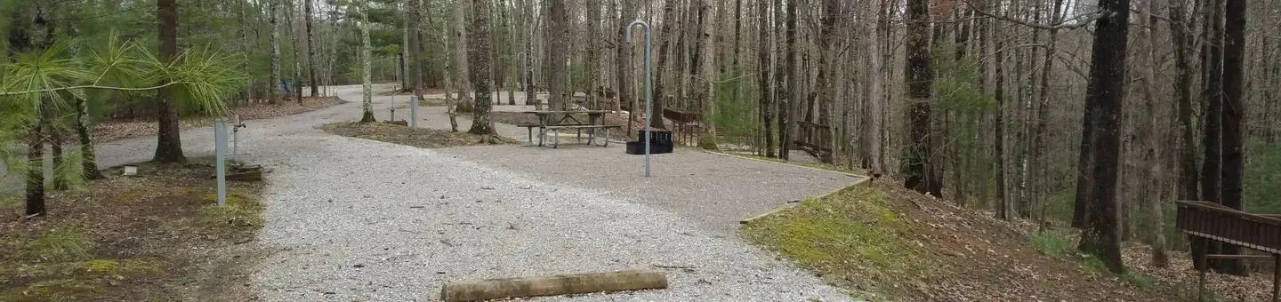 Rocky parking pad with campsite nearby.