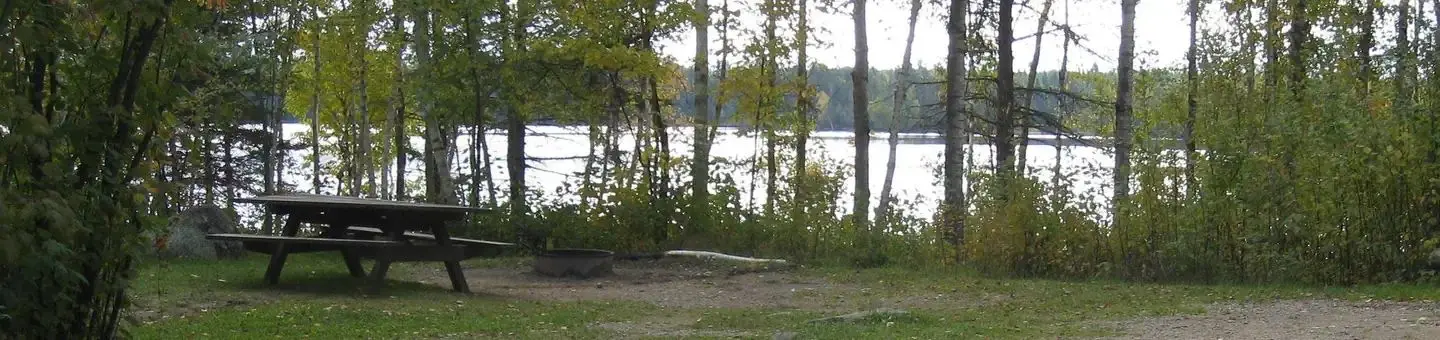 Picture of table with lake in the background.