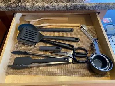 Cooking utensils include spatulas, mixing spoons and measuring cups.