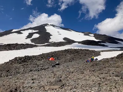 False summit of Mount Adams with tents and mountaineers at Lunch Counter