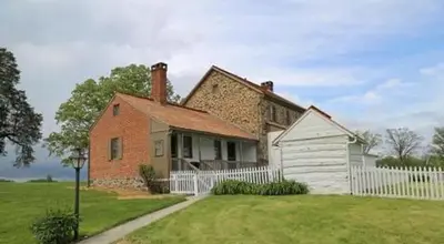 Back porch of house with fenced in yard