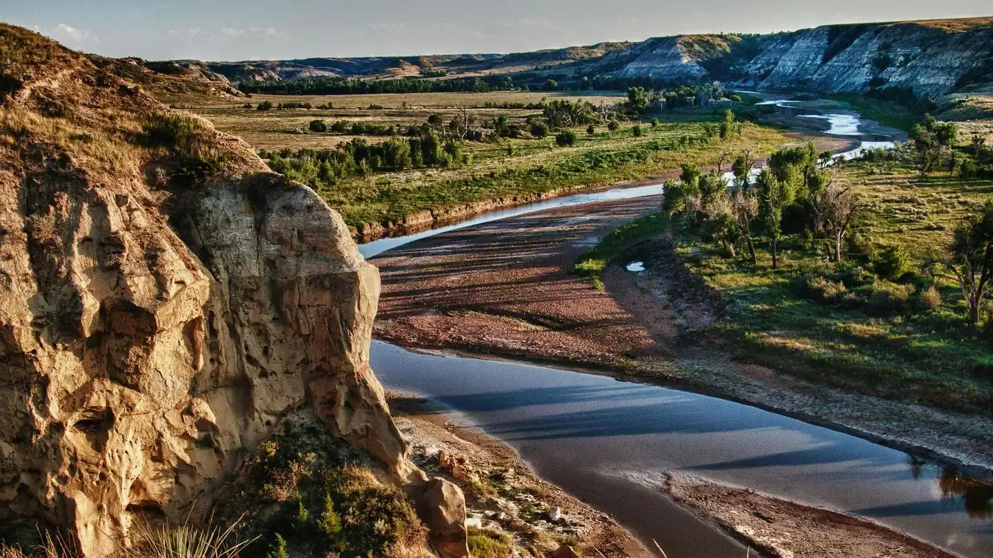 A scenic view of the Little Missouri River winding through the Badlands as seen from the Wind Canyon Trail