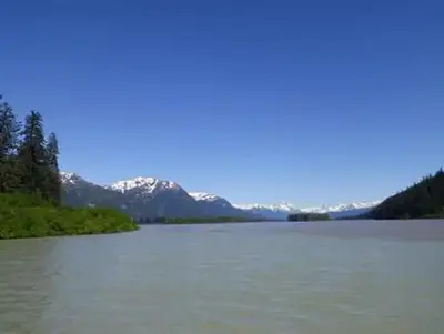 Shakes Slough 1 Cabin view featuring snowcapped mountains and water in foreground