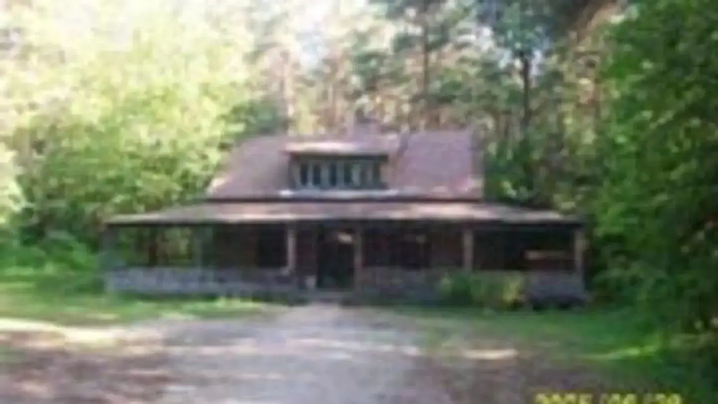 Exterior of a wooden cabin with a large front porch