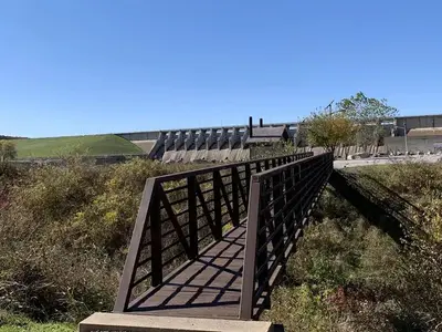 Pedestrian bridge located in Brush Creek for fishermen and visitors to walk across and visit the Keystone Dam structure to fish or sight see.