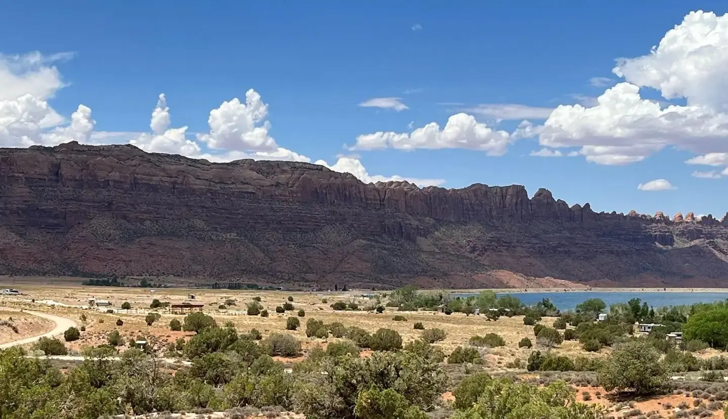 Overview of Ken's Lake Campground with red rock cliffs lining the horizon.