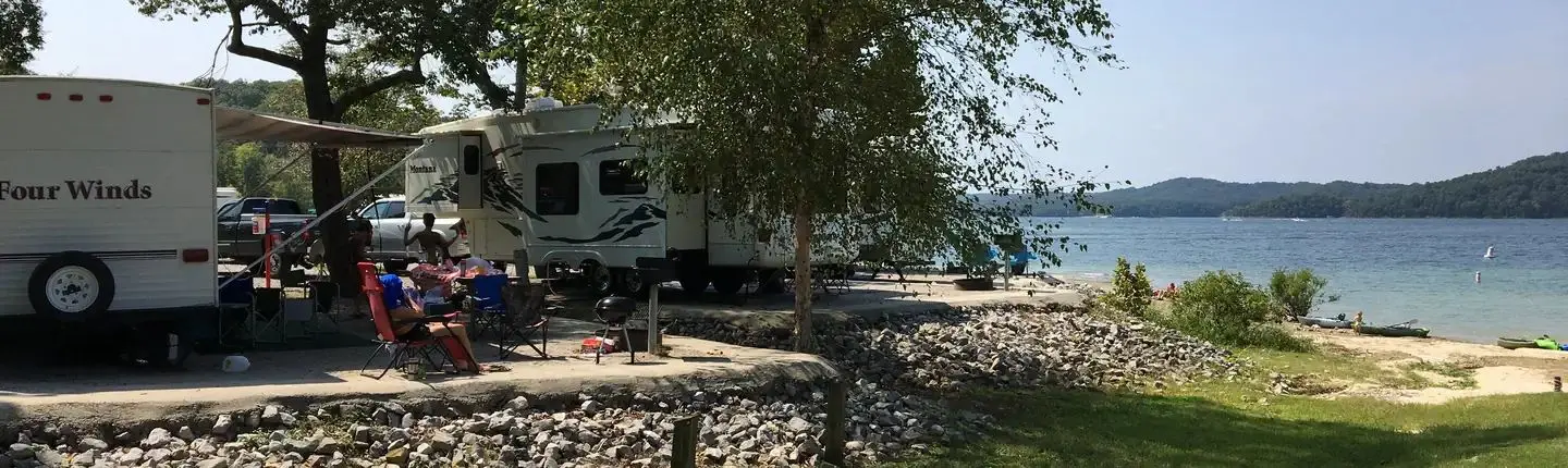Lillydale Campground and Day Use view from beach with RV, campers and lake in background
