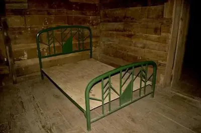 Full size metal bed frame inside cabin