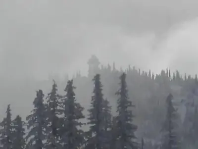 snowy lookout in the distance with fog