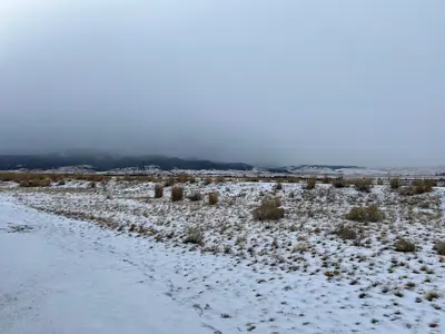 Foothills of the Anaconda Range obscured by clouds in winter
