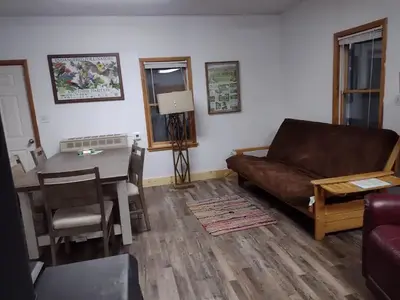 Living room of cabin with sofa, dining table and lamp