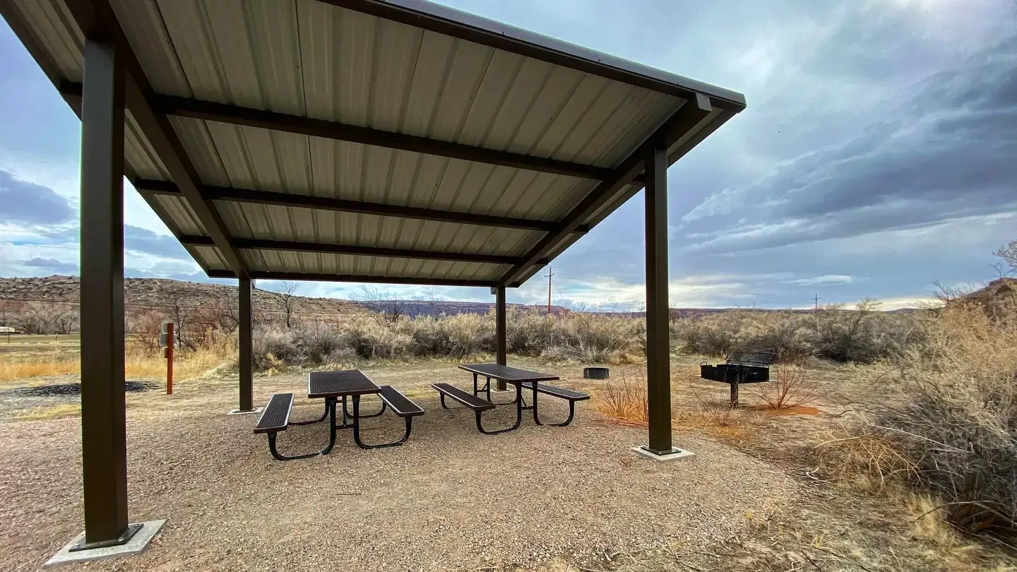 Westwater Group Site picnic tables underneath shade shelter.