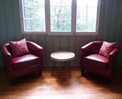 Two red chairs and a coffee table in living room.