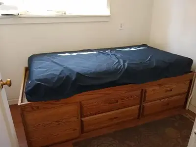 A twin sized mattress with storage underneath.