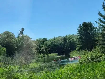 Group kayaking and inner tube floating on the Platte River