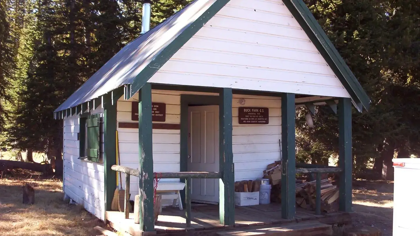 BUCK PARK CABIN - Front of white and green cabin