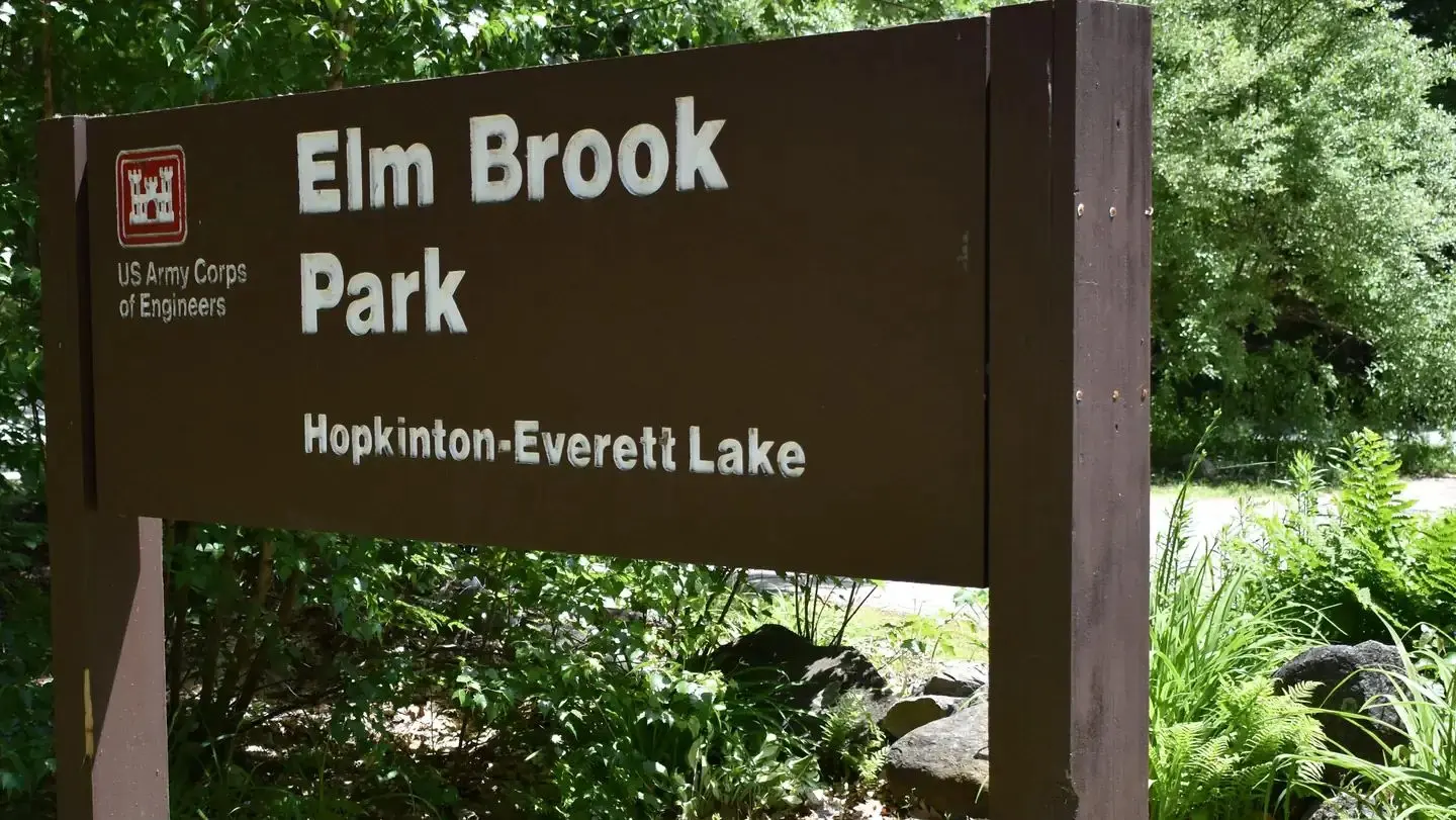 A close-up of the Elm Brook Park sign near the main entrance of the park.