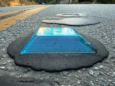 2025-08-09 07 32 07 A blue raised pavement marker along Bear Creek Road in Boulder Creek, Santa Cruz County, California