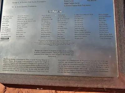 Closeup of the historic plaque with details about the historic Dewey Suspension Bridge in Utah on route 128