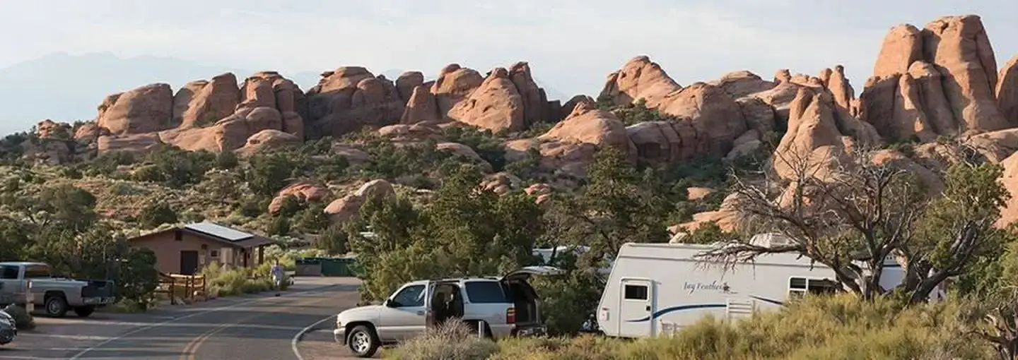 Campground road lined with campsites and boulders in the background