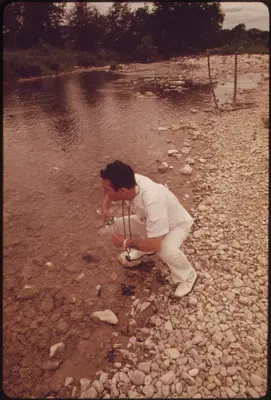 A Local Health Officer Taking a Water Sample from the Frio River near Leakey, Texas, near San Antonio, 05-1973 (3703573029)