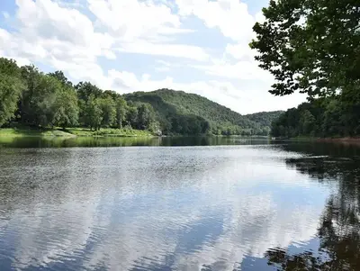 The Potomac River reflects a blue sky and fluffy clouds at McCoys Ferry