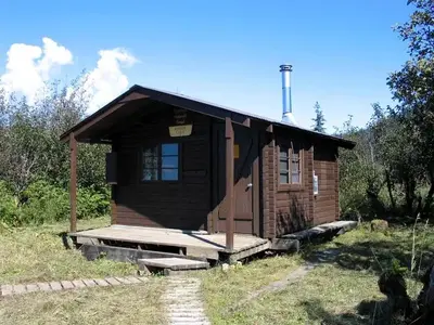 Koknuk cabin with two wood plank trails leading to it