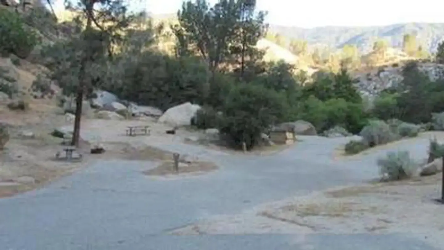 Paved driveway and parking spurs in a desert campground.