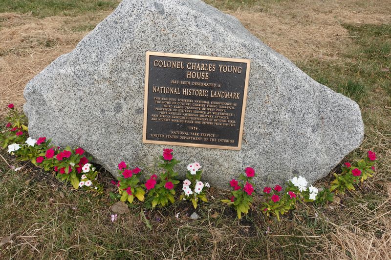 A large gray stone boulder with a bronze plaque on it indicating a national historical landmark