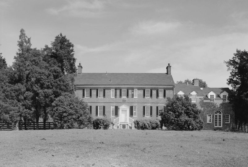 black and white photo of a large two story brick manor