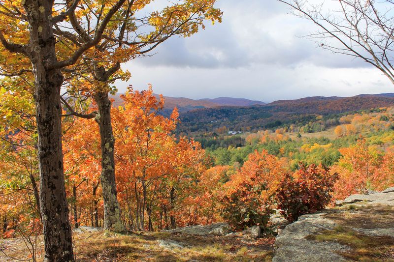 scenic overlook with town below surrounded by fall foliage