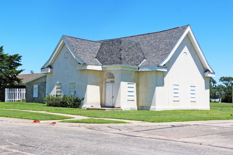 A limestone stucco building on a street corner