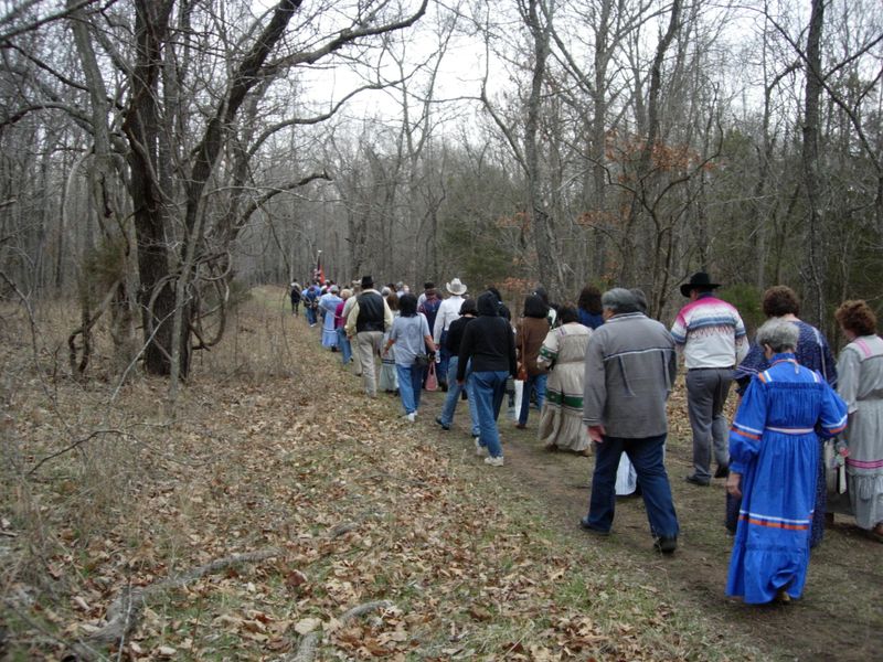 dozens of people walk a section of the Trail of Tears, winter scene, trees with no leaves