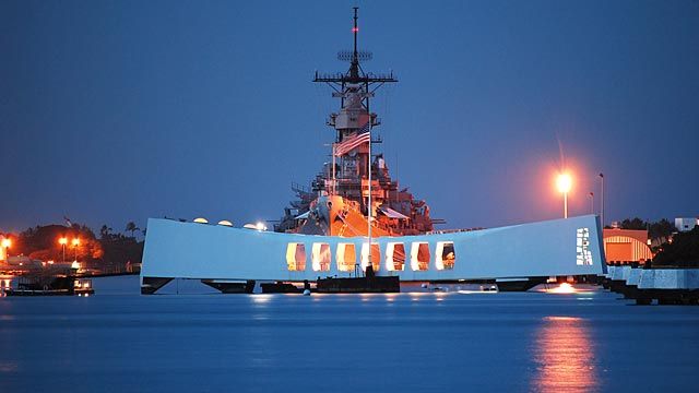 The USS Arizona Memorial in front of the USS Missouri.