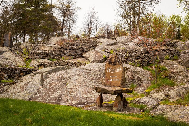 Photograph of landscape with large boulders and rock sculptures.